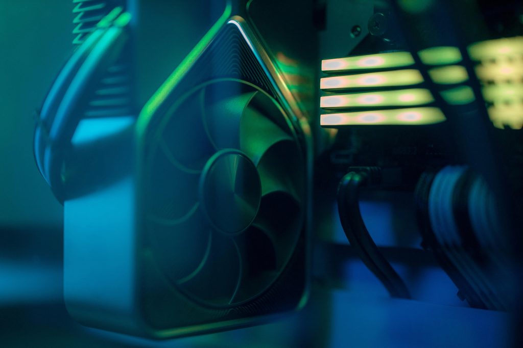 Detailed close-up of a computer cooling fan inside a custom PC with LED lighting, emphasizing technology and design.